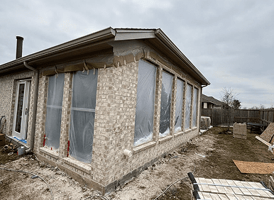 Brick structure in progress with covered windows