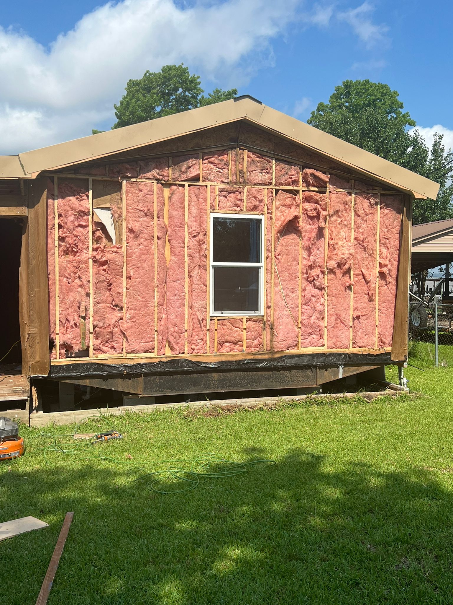 House exterior stripped to insulation during renovation.