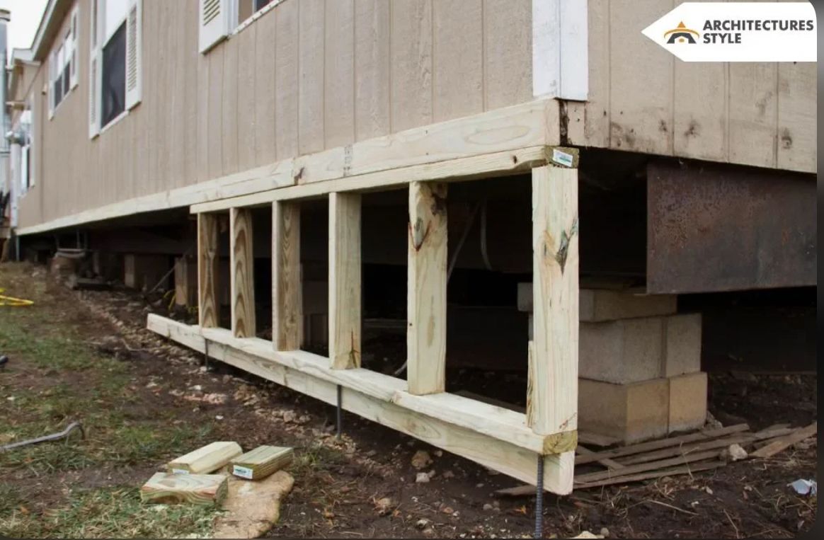 Wooden house foundation with exposed beams and blocks.
