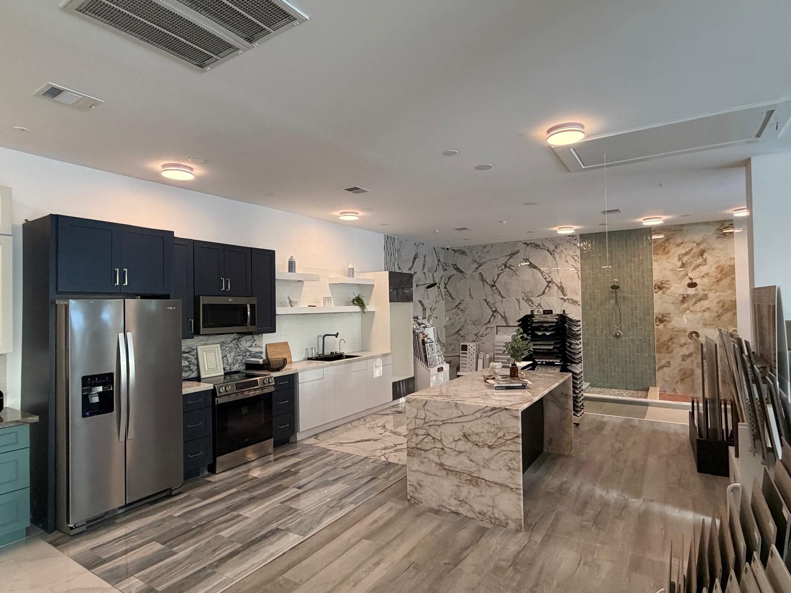 Modern kitchen with marble island and stainless steel appliances.